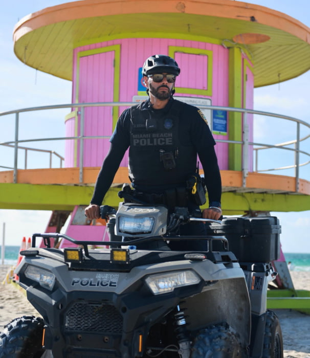 A police officer on an ATV on the beach